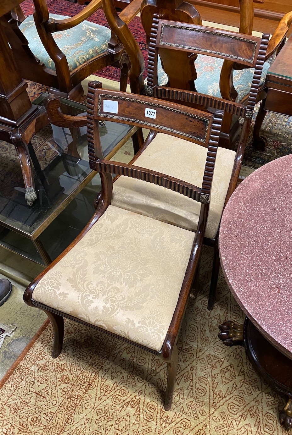 A pair of Regency brass mounted mahogany dining chairs